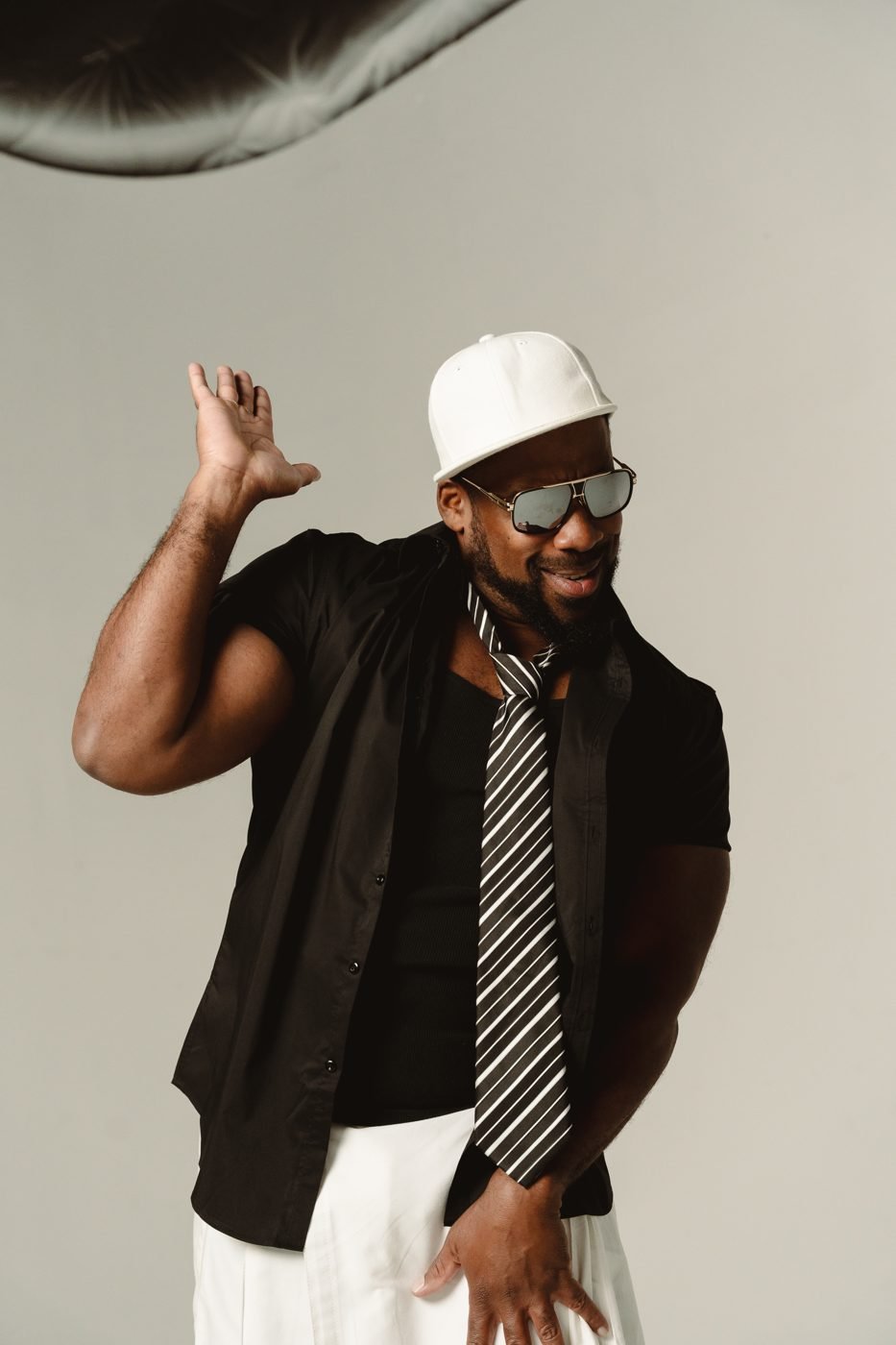 Bad Juju striking a pose in a black shirt and white kilt